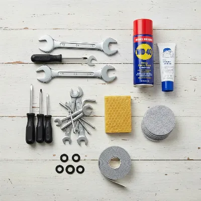 A collection of DIY tools and materials for fixing a squeaky bed frame