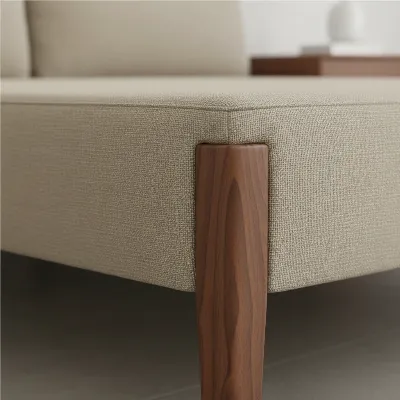 Close-up of the Article Tessu Upholstered Bed Frame's fabric texture and solid wood leg detail, emphasizing quality materials and craftsmanship in a bright setting. 