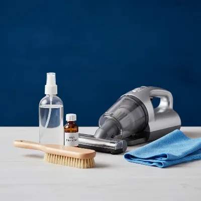 Essential velvet bed frame cleaning kit: soft brush, vacuum attachment, cleaning solutions.